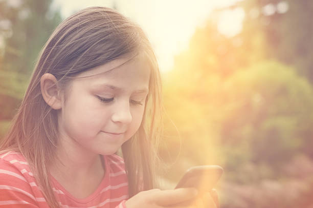 Little girl and a smart phone stock photo