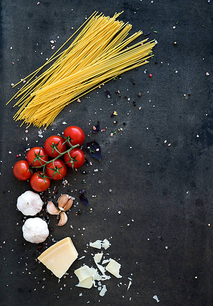 istock Food frame. Pasta ingredients. Cherry-tomatoes, spaghetti pasta, garlic, basil 477627548