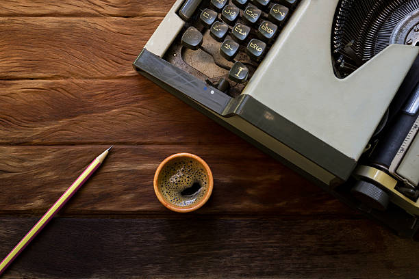 istock old typewriter with coffee on old wood texture 477629670