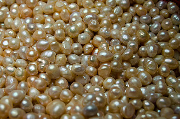 istock Oyster pearls grouped in a bowl 477631686