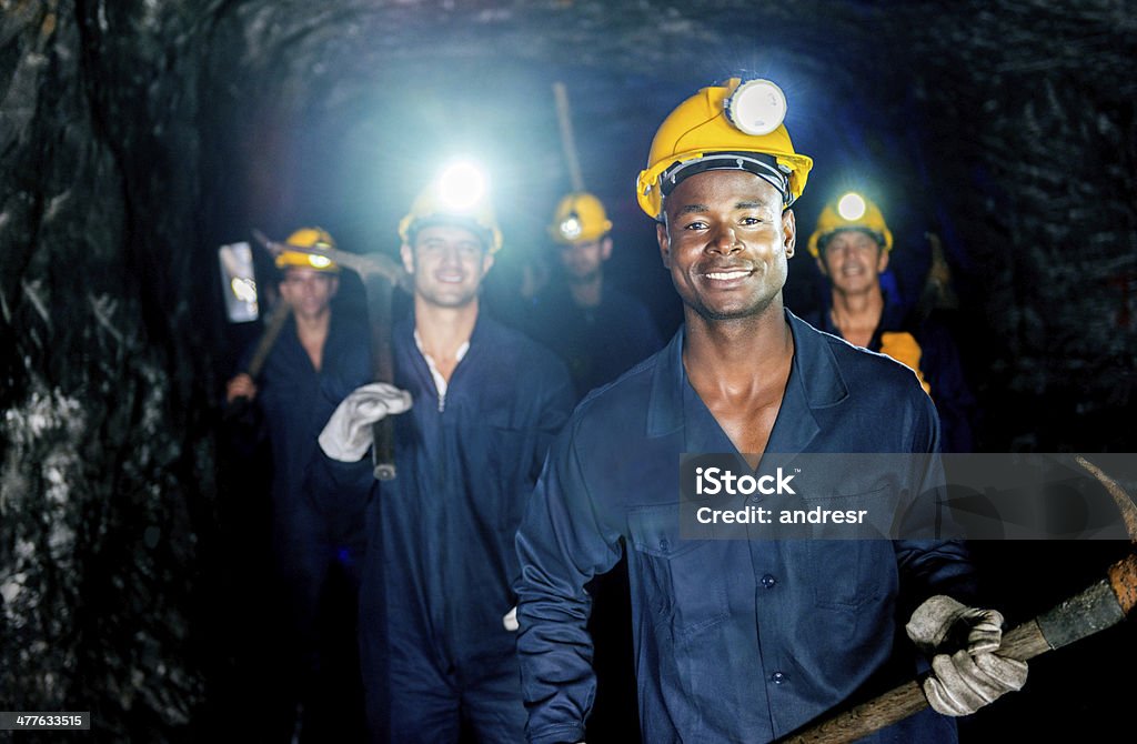 Group of miners Group of miners in a mine looking happy Mining - Natural Resources Stock Photo