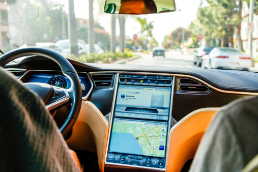 Los Angeles, United States - May 17, 2013: A cockpit with LCD digital speedometer and LCD touch screen of electric car Tesla Model S during drive in Santa Monica, Los Angeles, California. Tesla electric cars are produced by Tesla Motors, Inc. in California, USA.