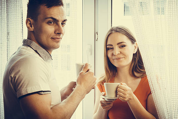 istock young couple drinking tea or coffee at home 477635686
