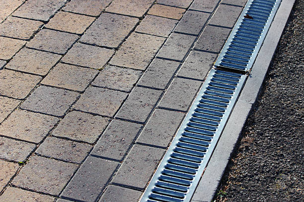 istock Image of linear drainage channel and grate by block-paving driveway 477637160