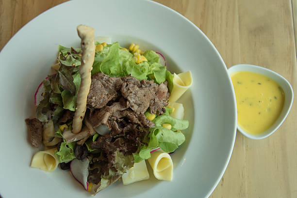istock meat cheese salad with lemon salad dressing 477637172
