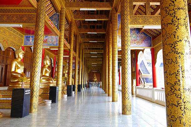 row of golden buddha statue in monastery in  thailand