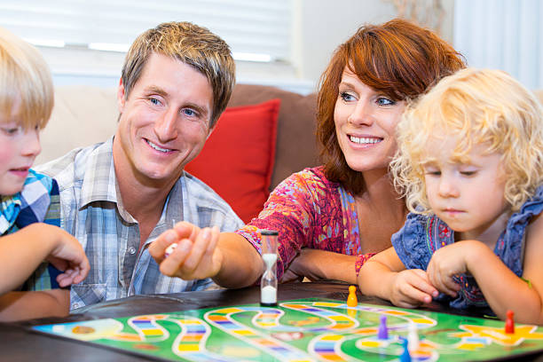 istock Family with two little kids having fun playing board games 477639549