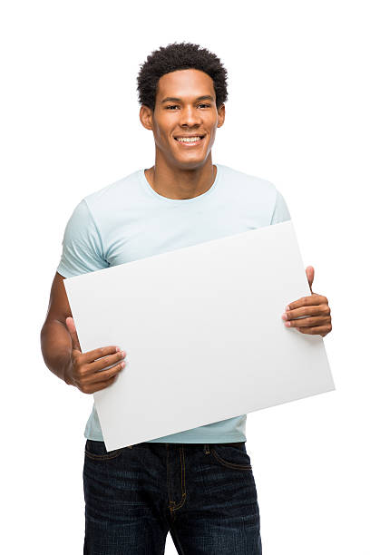 istock Young latin man holding sign 477639677