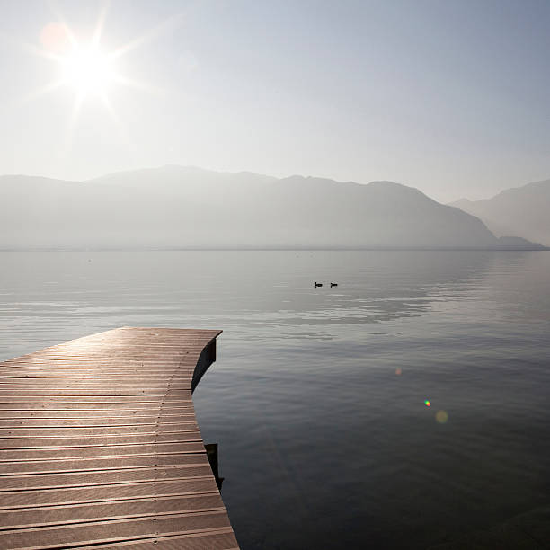 istock Sun shining over dock on Lake Maggiore 477640142