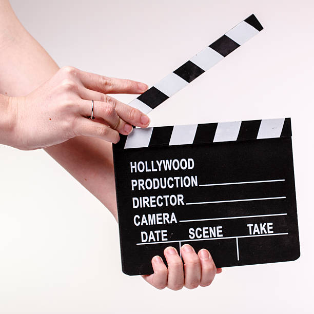 istock Movie flapper in woman´s hands on white background 477641343