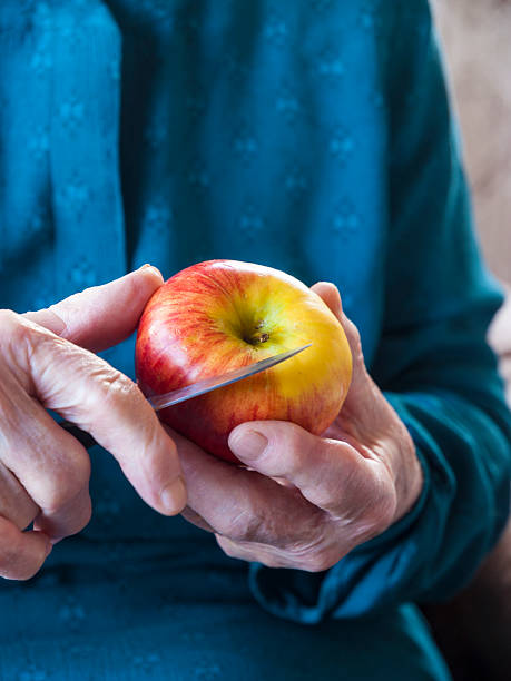 Old hands holding an apple stock photo