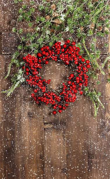 istock christmas tree branches and wreath from red berries 477643235