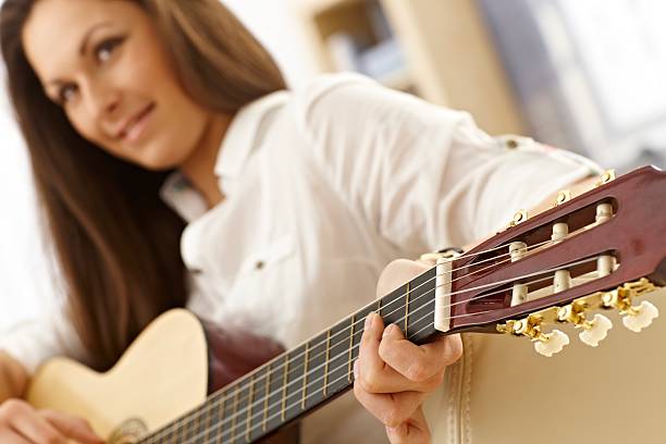 istock Young female guitarist 477644315