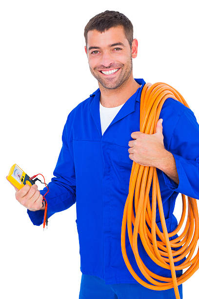 istock Smiling electrician with wire roll and multimeter 477644444