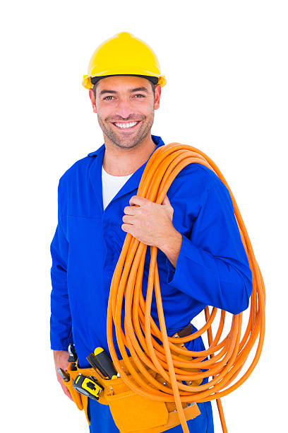 Smiling handyman with rolled wire on white background