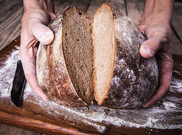 istock food. rye bread in male hands 477644594