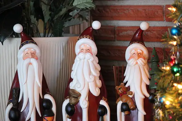 The image shows three wisemen figurines, wisemen dressed in Christmas colors. The image was shot in Idaho, USA.