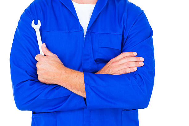 istock Male mechanic holding spanner on white background 477645034