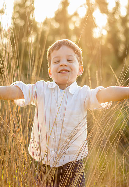 istock Kid in field playing with spikes at summer sunset 477650915