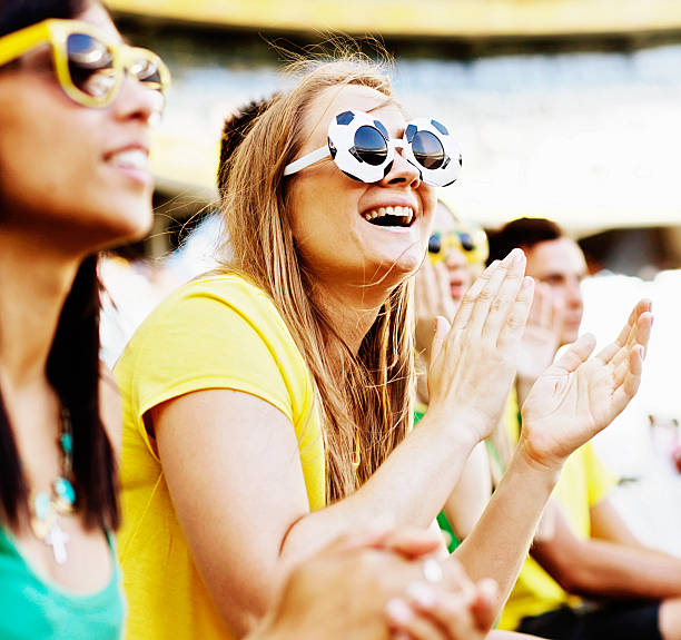 istock Two pretty soccer fans supporting their team at a match 477652919
