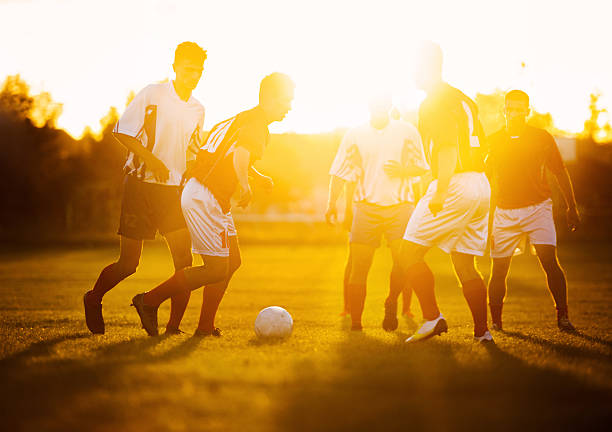 istock Soccer players in action at sunset. 477652999
