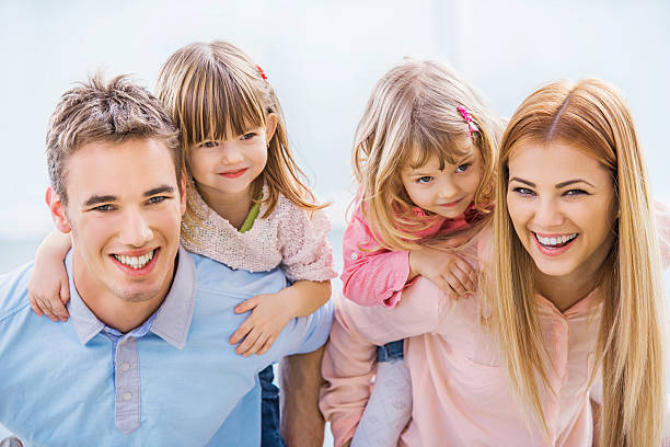istock Young parents piggybacking their children. 477653069