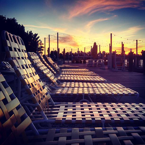 istock Winter Sunset Over Pool Chairs in Miami Beach 477653585