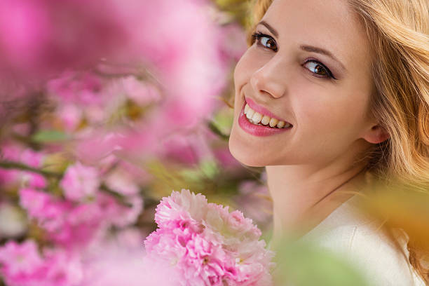 istock Beautiful woman in spring garden 477660376