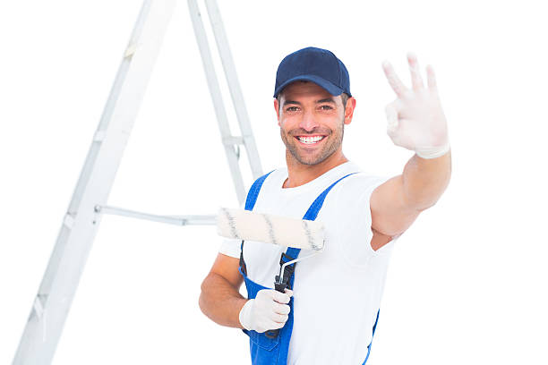 istock Happy handyman with paint roller gesturing okay 477662976