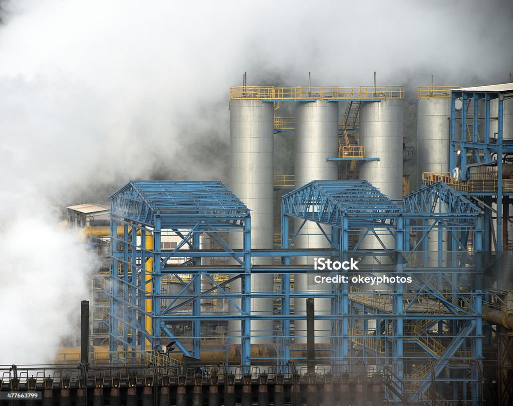 Industry - Steaming and Smoking Heavy industriy building and steam in Turkey Air Pollution Stock Photo