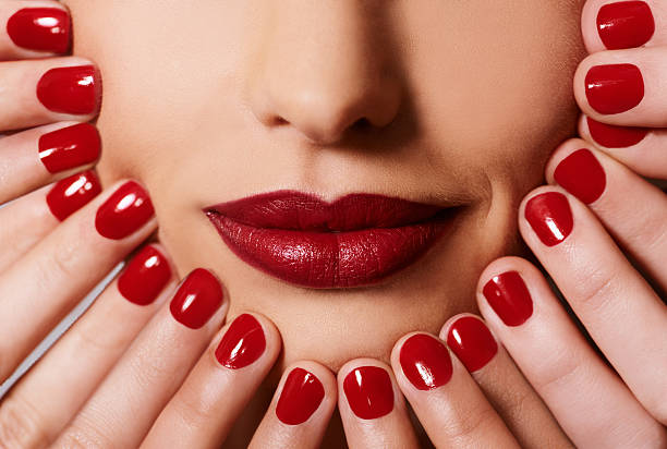 Complimentary colours Hands touching the face of a woman wearing red lipstick same person multiple images stock pictures, royalty-free photos & images