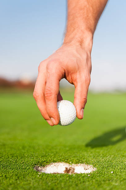 istock Golfer Picking Up The Ball 477665171