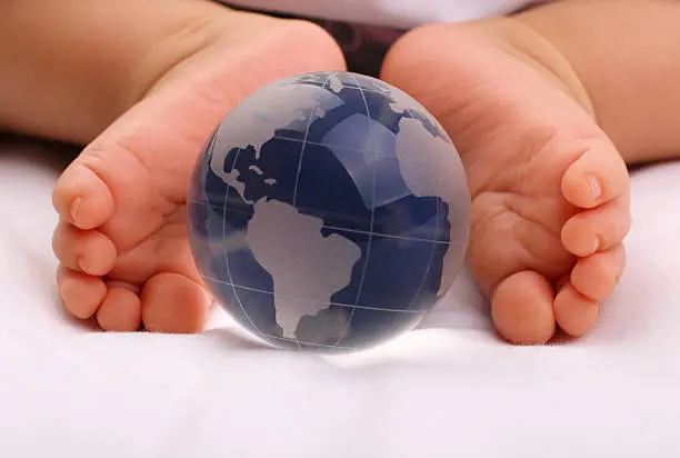 Photo of Glass globe and baby feet