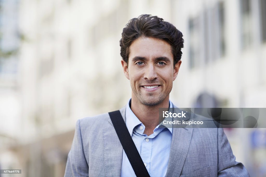 He's taking his career places! An attractive businessman smiling while in the city central 20-24 Years Stock Photo