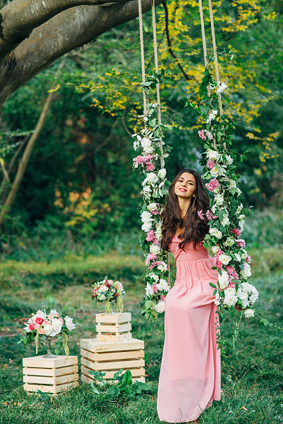 istock Beautiful young girl on a swing 477670128
