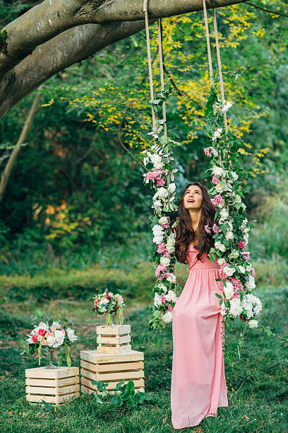 istock Beautiful young girl on a swing 477670130