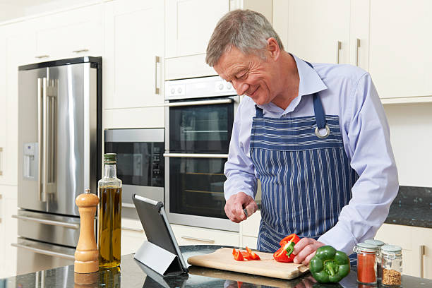 istock Senior Man Following Recipe On Digital Tablet 477670603