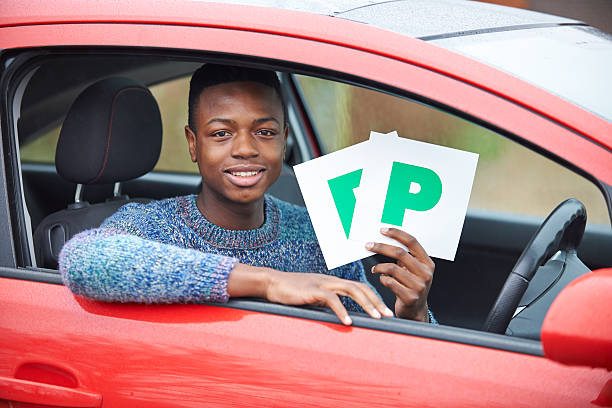 istock Teenage Boy Recently Passed Driving Test Holding P Plates 477670611