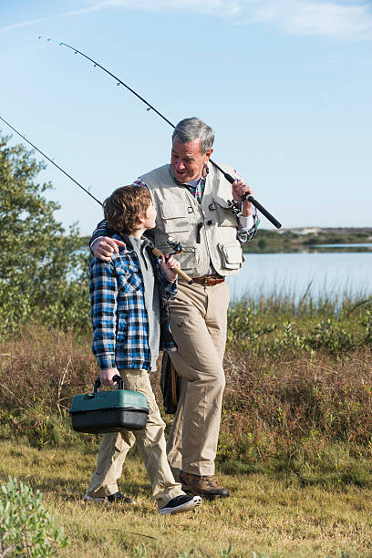 istock Boy fishing with grandfather 477671073