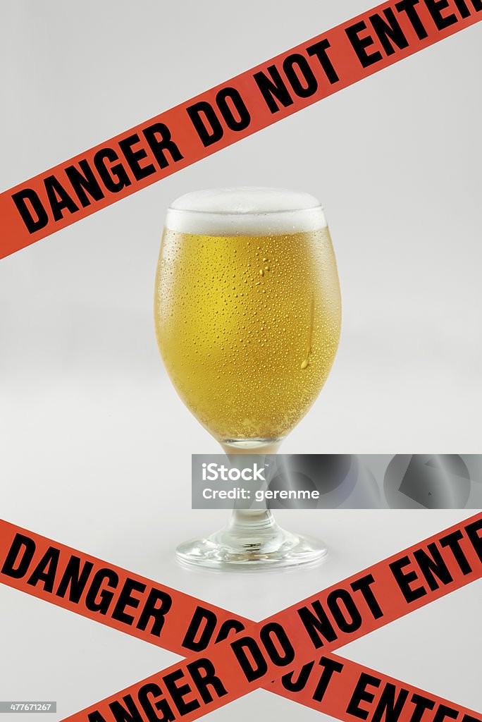 Do Not Drink Alcohol Danger sign in front of a beer glass. Alcohol - Drink Stock Photo