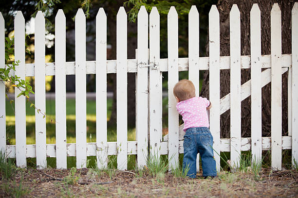 istock Baby Standing at a Fence 477671425