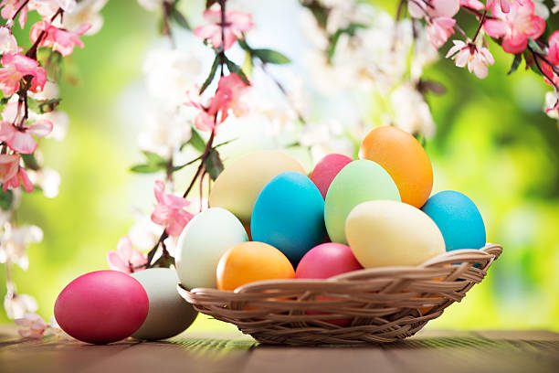 istock Colorful easter eggs and spring flowers on green nature background 477671487
