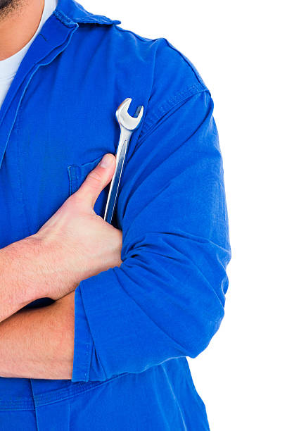 istock Male mechanic holding spanner on white background 477673872