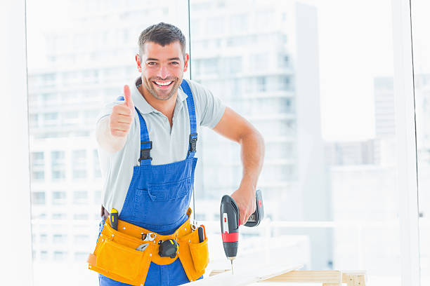 istock Happy handyman drilling hole in plank while gesturing thumbs up 477676338