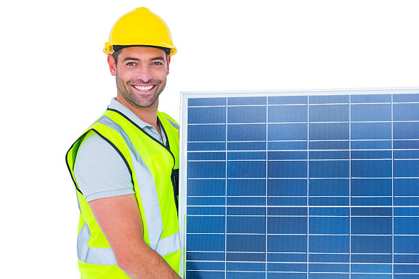 istock Smiling handyman in protective clothing carrying solar panel 477678836