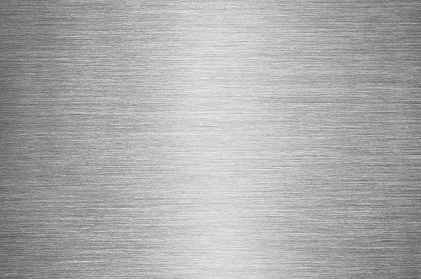 Gray Brushed Metal Texture Background - Steel or Aluminium Real macro shot of a brushed metal surface, with reflected light in the centre of image. sheet metal photos stock pictures, royalty-free photos & images