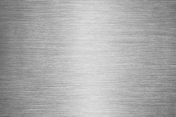Gray Brushed Metal Texture Background - Steel or Aluminium Real macro shot of a brushed metal surface, with reflected light in the centre of image. metallic stock pictures, royalty-free photos & images