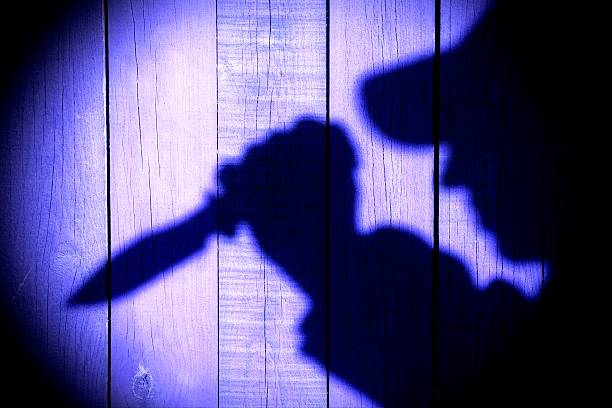 istock Silhouette with knife on the Natural Wooden Panel 477679781