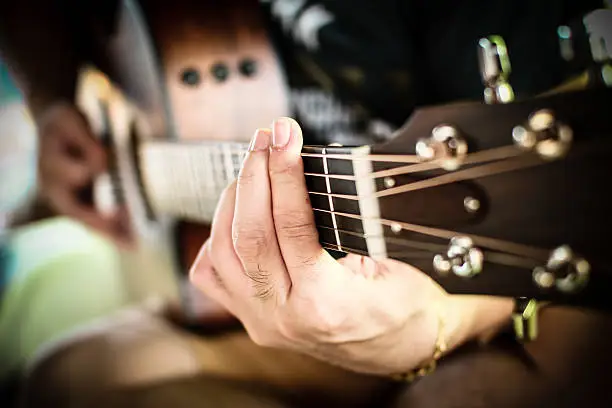 Photo of Playing guitar close up. selective focus image