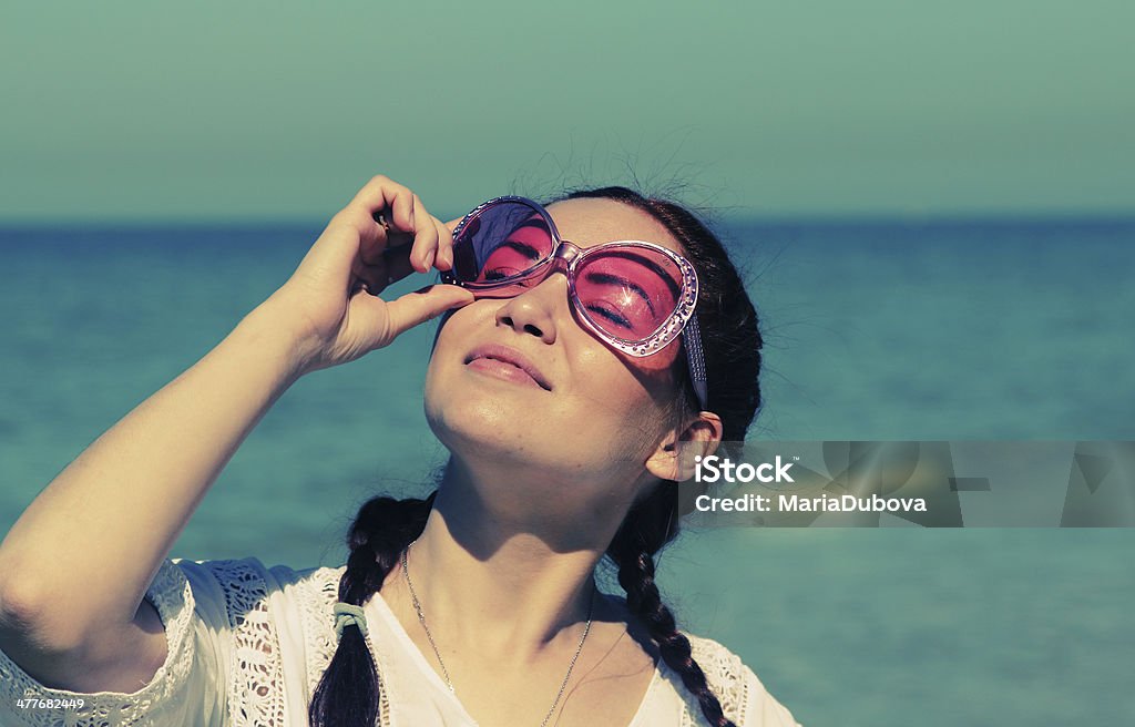 beautiful woman in pink sunglasses Portrait of beautiful woman in pink sunglasses Adult Stock Photo